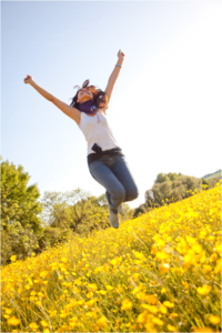 Jumping Woman in Yellow Field